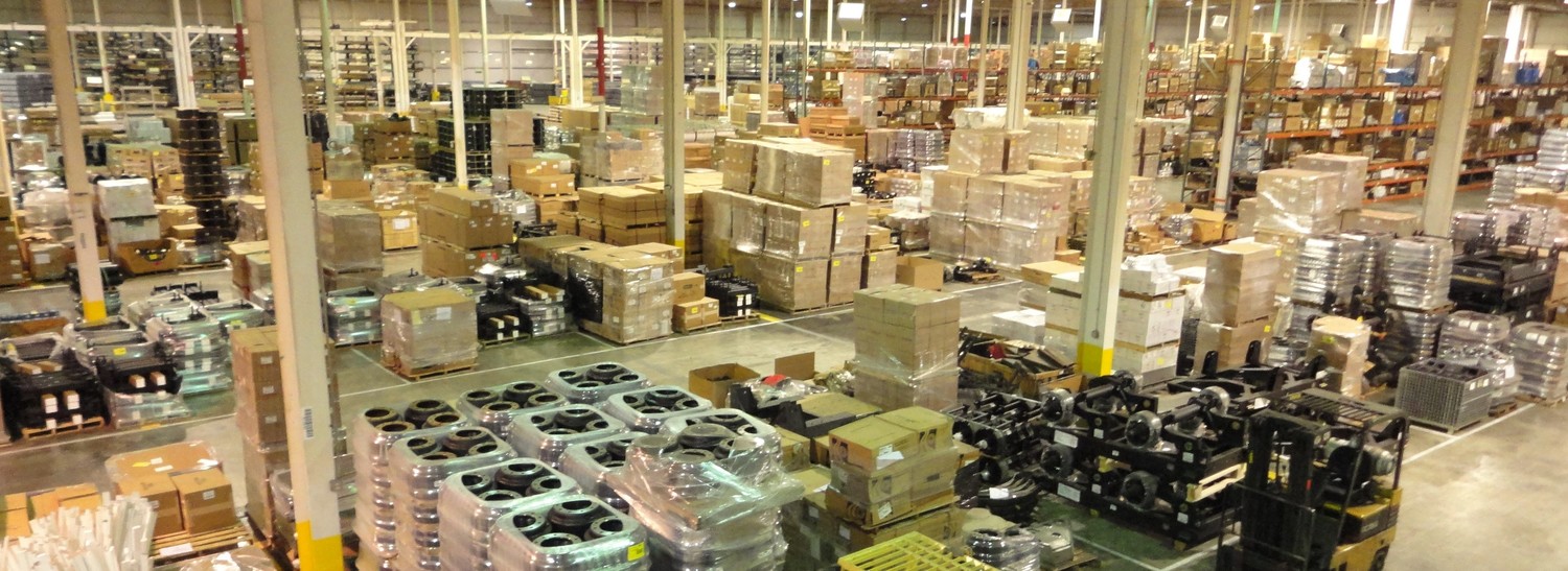 A warehouse filled with various semi trailer equipment and parts